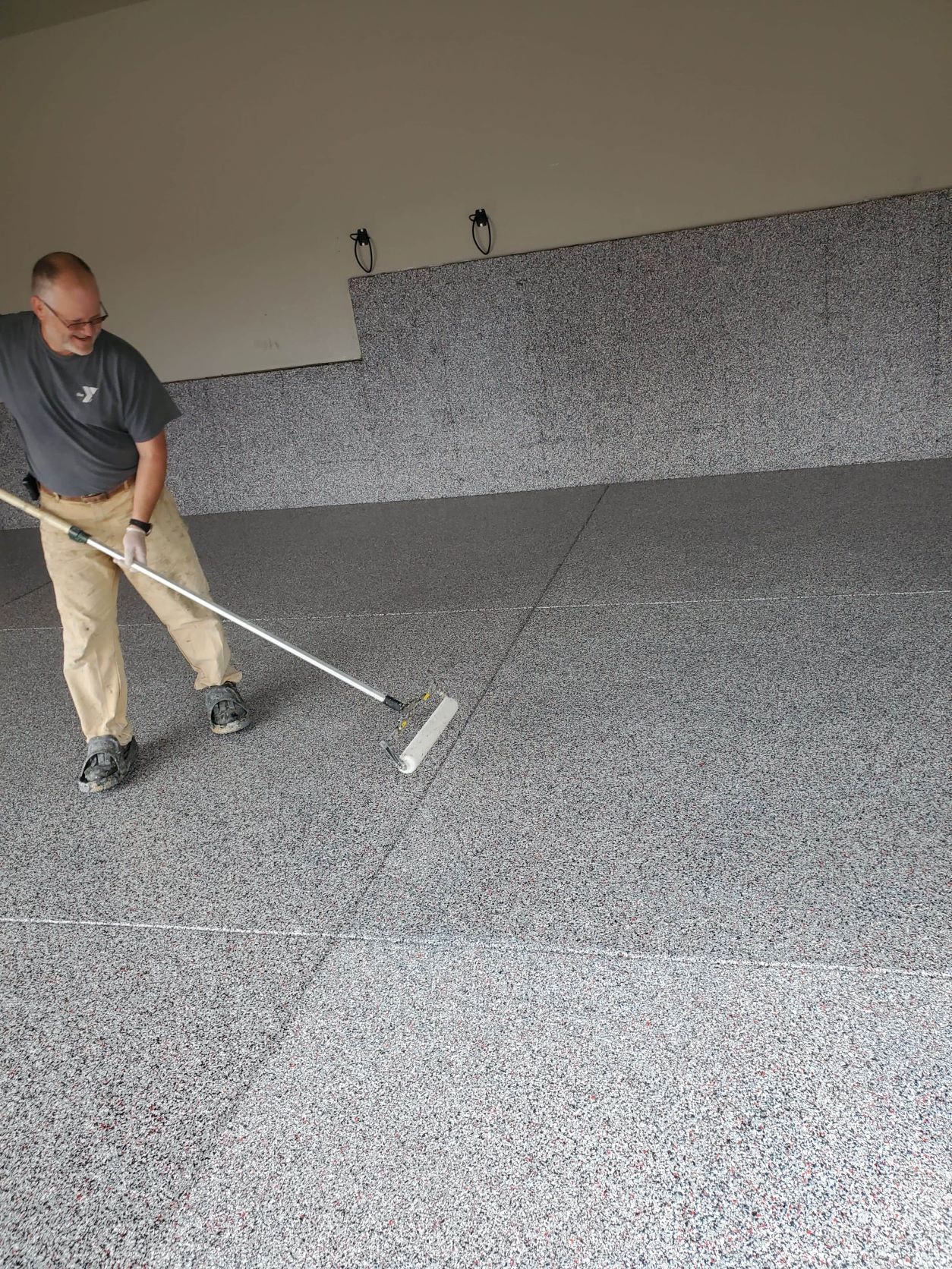 Professional rolling of polyaspartic top coat in Colorado Springs