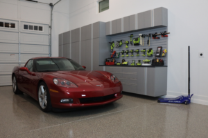 red car in garage, custom garage floors and garage cabinets