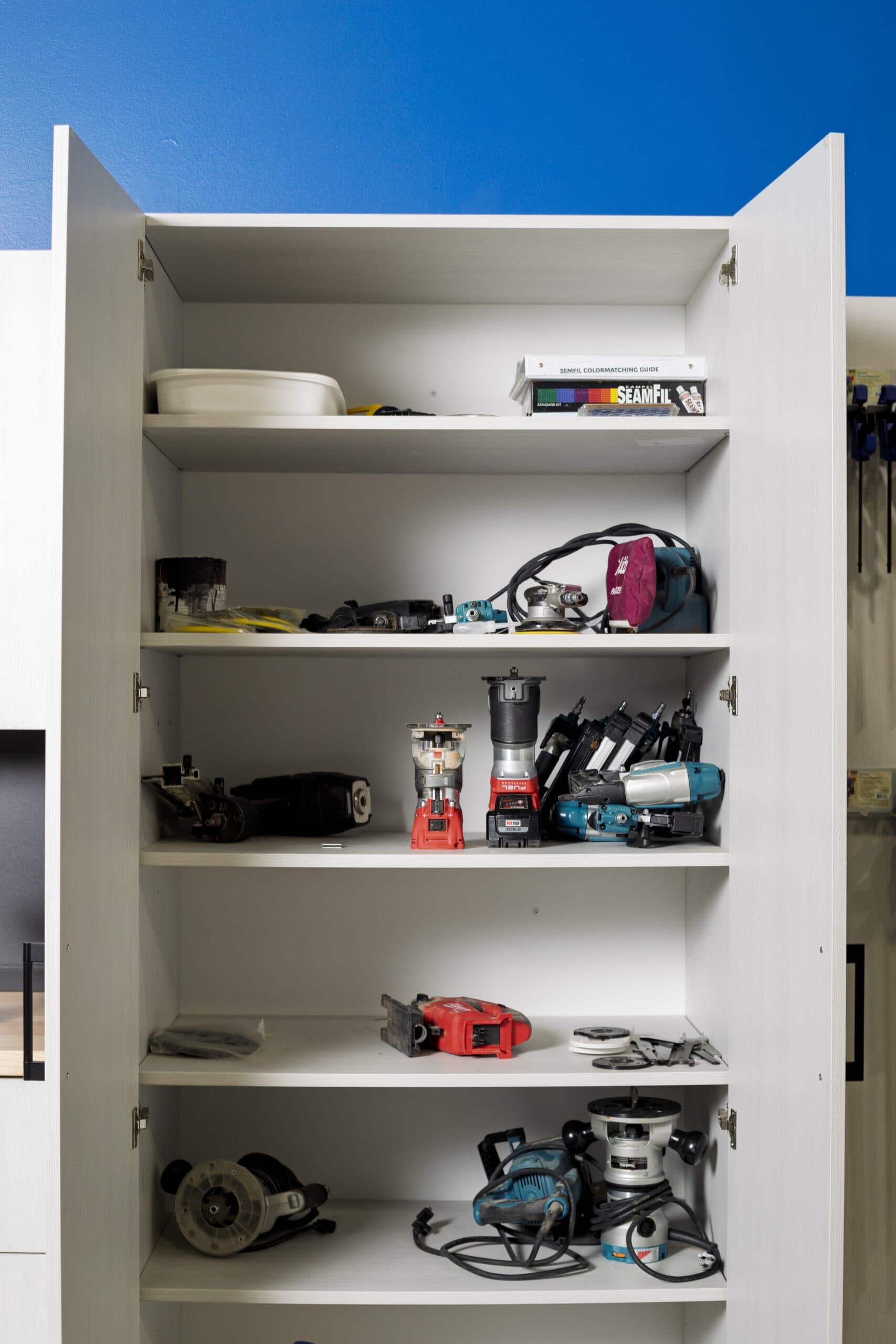 White garage cabinets with doors open showing interior shelving — Colorado Springs Garage Floors