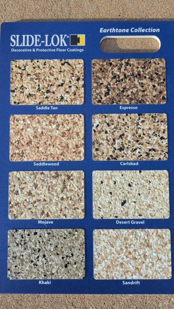 Slide-Lok Earthtone Collection flake sample board showing Saddle Tan, Espresso, Saddlewood, Carlsbad, Mojave, Desert Gravel, Khaki, and Sandrift garage floor blends