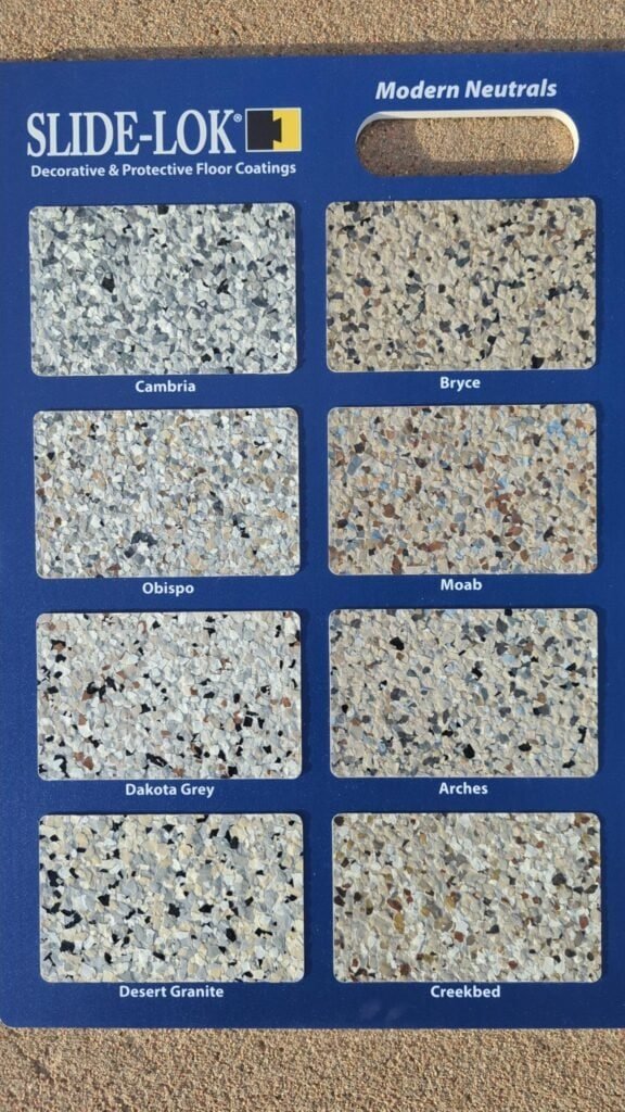 Slide-Lok Modern Neutrals flake sample board showing Cambria, Bryce, Obispo, Moab, Dakota Grey, Arches, Desert Granite, and Creekbed garage floor blends