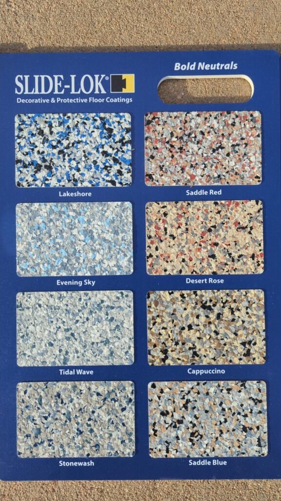 Slide-Lok Bold Neutrals flake sample board showing Lakeshore, Saddle Red, Evening Sky, Desert Rose, Tidal Wave, Cappuccino, Stonewash, and Saddle Blue garage floor blends